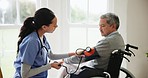 Blood pressure, nurse and senior man in wheelchair for medical care, wellness and service. Healthcare, retirement home and caregiver with heart rate machine on person with disability for cardiology