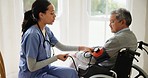 Blood pressure, nurse and old man in wheelchair in house for medical care, wellness or service. Healthcare, retirement home and caregiver with heart rate machine on person with disability for support