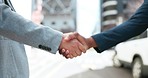 Business people, city and shaking hands for agreement of deal, b2b promotion or success of negotiation. Closeup, team handshake and introduction of partnership, support integration and reward outdoor