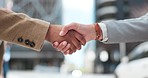 Business people, collaboration and shaking hands in city for agreement, b2b deal or praise success. Closeup, team handshake and introduction of partnership, support integration or negotiation outdoor