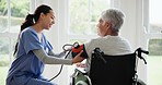 Blood pressure, nurse and senior woman in wheelchair for medical care, wellness and service. Healthcare, retirement home and caregiver with heart rate machine on person with disability for cardiology