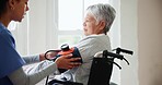 Blood pressure, caregiver and senior woman in wheelchair for medical care, wellness and service. Healthcare, retirement home and nurse with heart rate machine on person with disability for cardiology