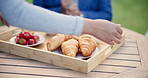 Hands, breakfast a nurse serving senior people in the garden of a retirement home closeup for nutrition. Food, coffee and assisted living with elderly people in the backyard for health, diet or care