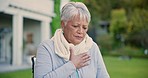 Chest pain, park and senior woman in wheelchair for emergency, injury and heart attack outdoors. Healthcare, retirement and elderly person in nature with heartburn, cardiovascular problem and hurt