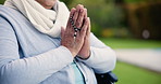 Hands, praying with cross and worship, trust and faith in God and patient in wheelchair. Person with disability outdoor with crucifix, prayer and respect, guide and help with health and religion