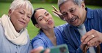 Nurse, senior people and funny selfie with peace sign language, memory or laugh in nursing home garden. Old couple, caregiver and photography for profile picture, social media update or kiss on vlog