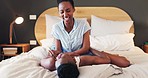 Bedroom love, home and laughing black couple having fun, bonding or enjoy relationship games, morning together or tickling. Partner, bed and happy man, woman or marriage people smile for funny humour