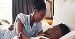 Bed, love and African couple talking in bedroom together with care in relationship and with happiness in the morning. Calm, bonding and happy man with woman for romance to relax in room on vacation