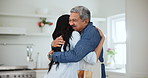 Father, daughter and reunion with hug, excited and welcome in kitchen of family home or happiness. Wow, dad and woman with surprise visit with love embrace and smile for holiday, vacation or weekend