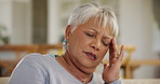 Stress, headache and a senior woman in the living room of her home closeup with pain or fever. Depression, burnout or mental health with an elderly person alone in her apartment for retirement