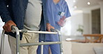 Hands, walker and a caregiver helping a patient in an assisted living home for senior care or retirement. Medical, healthcare or assistance with a nurse and elderly person in a house for recovery