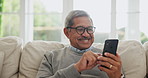 Senior man search phone in home for social media, reading mobile news article and online contact with glasses. Happy retirement, smartphone and download digital app for chat, notification and texting
