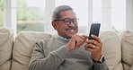Senior, happy man and typing with phone in home for social media, reading news article and information with glasses. Retirement, mobile contact and download digital app for multimedia subscription 