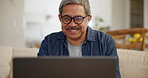 Laptop, smile and a senior man streaming a subscription service in the living room of his home to relax. Computer, series or entertainment with a happy elderly person watching a movie or video