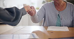 Handshake, deal and an insurance agent with a senior person in the home for finance or retirement planning. Thank you, contract and people shaking hands closeup for an investment or savings agreement