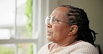 Mature woman, anxiety and thinking on retirement, stress and worry by window for future. Black female person, depression and nervous for nursing home, fear and doubt or regret for decision and lonely