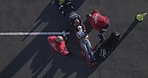 Emergency, accident and aerial of people on street for injury, first aid and car crash for saving patient. Paramedic, ambulance and health emt with person for medical service, care and healthcare