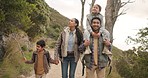 Happy family, hiking and holding hands in nature, piggyback and care outdoor. Mother, father and kids trekking in forest, walk in woods or travel together on vacation, talking or bonding on adventure