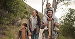 Happy family, hiking and holding hands in forest, piggyback and care outdoor. Mother, father and kids trekking in nature, walk in woods or travel together on vacation, talking or bonding on adventure