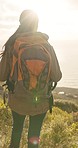 Backpacking, hiking and woman with fitness, adventure and fresh air with wellness, journey and mountains. Person, hiker or traveller with a bag, lens flare or exercise with woods, trekking or outdoor