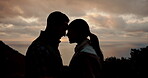 Couple, silhouette and love on hike by sunset, forehead touch and bonding for marriage on mountain. Happy man and woman, trekking and adventure or travel, vacation and holiday for anniversary trip