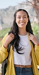 Hiking, nature and face of happy woman on mountain with backpack for adventure, trekking and freedom. Travel, holiday and portrait of person smile outdoors walking for wellness, vacation and exercise