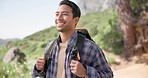 Hiking, nature and man on mountain with backpack for adventure, trekking and freedom. Travel, fitness and happy person outdoors walking for wellness, fresh air and exercise on holiday or vacation
