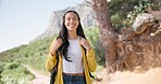 Hiking, nature and face of woman on mountain with backpack for adventure, trekking and freedom. Travel, holiday and portrait of happy person smile outdoors walking for wellness, vacation and exercise