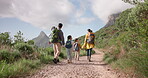 Family hiking, nature and walking in forest for fitness and bonding, parents and kids holding hands with back view. Sightseeing, travel and adventure with man, woman and children outdoor in mountains