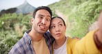 Couple, face and crazy selfie in nature for hiking, travel or adventure together. Portrait, funny and travel influencer people in a forest for social media profile picture, blog or podcast update