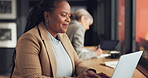 Business woman, computer and happy at workspace for online research, marketing and social media report. African employee with copywriting feedback, internet and research on laptop by office window