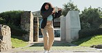 Dance, fashion and a woman walking outdoor in a park during summer for freedom or movement in rhythm. Portrait, smile or energy with a happy young person moving to music in a garden for stress relief