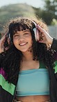 Dance, energy and headphones with a woman walking in a park during summer for freedom or movement in rhythm. Face, smile or fashion with a happy young person moving closeup to music for stress relief