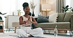 Yoga, praying or black woman in meditation for wellness, peace or balance in home or apartment. Calm, relax or zen African person in pilates pose for energy training, breathe or holistic exercise  