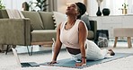 Yoga, laptop and zen with a black woman on the floor of a living room in her home for health or wellness. Exercise, computer and mental health with a young person in her apartment for mindfulness