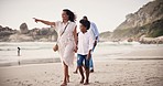 Family, together and walk on vacation by beach pointing to horizon in Cape Town. Mother, son and holding hands for bond, safety or love in relationship on holiday, trip or travel to sea for adventure