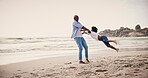 Black family, beach and a father spinning his son on the sand by the ocean or sea for love or fun in summer. Kids, travel or freedom with a man and boy child by the water on holiday or vacation