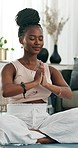 Yoga, praying or black woman in meditation in home or house studio for wellness, peace or balance. Calm, relax or zen African person in pilates pose for energy training, breathe or holistic exercise