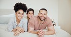 Happy, face and parents with a child on the bed for relaxing, bonding or resting together at home. Smile, happiness and portrait of young mother and father laying with boy kid in the bedroom at house