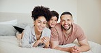 Smile, face and parents with a child on the bed for relaxing, bonding or resting together at home. Happy, excited and portrait of young mother and father laying with boy kid in the bedroom at house