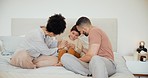 Happy, bed and parents tickling child at their home having fun and bonding together on a weekend. Smile, playful and young mother and father playing with boy kid in bedroom of modern house in Canada.