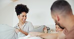 Happy, bed and parents in pillow fight with kid at their home having fun and bonding together on weekend. Smile, playful and young mom and dad playing with boy child in bedroom of house in Canada.