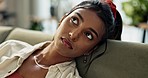 Woman, couch and thinking with sad eyes with emotion, face and living room with confused or disappointed. Indian person, mind and doubt in worry thoughts with anxiety, depression and problem in life