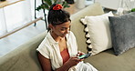 Woman, phone and top view with communication on sofa for conversation, typing or email in living room of home. Indian, person and smartphone for texting with internet or technology on couch in lounge