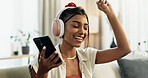 Woman, phone and headphones for dance on sofa, smile and relax with music, sound and mobile app. Girl, smartphone and audio streaming subscription for singing, listening and funny on lounge couch