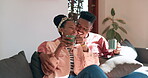 Coffee, black couple and home sofa with love, marriage and care in the morning with discussion. Tea, hot drink and conversation with happy people together in a living room with a smile in house