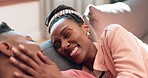 Happy woman, face and relax black couple laughing at funny conversation, relationship humour and bonding with partner. Home, comedy and African man, woman or apartment people joke on living room sofa