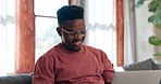 Man, glasses and thinking for typing in living room for message by email on sofa. Black person, happy and excited with technology for internet, web, or app for communication, remote or work from home