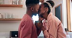 Kiss, kitchen and happy black couple with coffee, conversation and connect with romantic care, support and affection. Love, morning wellness and relax African man, woman or home people bond together