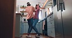 Happy man, woman and dancing in kitchen for fun, bond and relationship with love. African people, married and silly in excitement with care for activity in home for celebrate, wellness and energy
